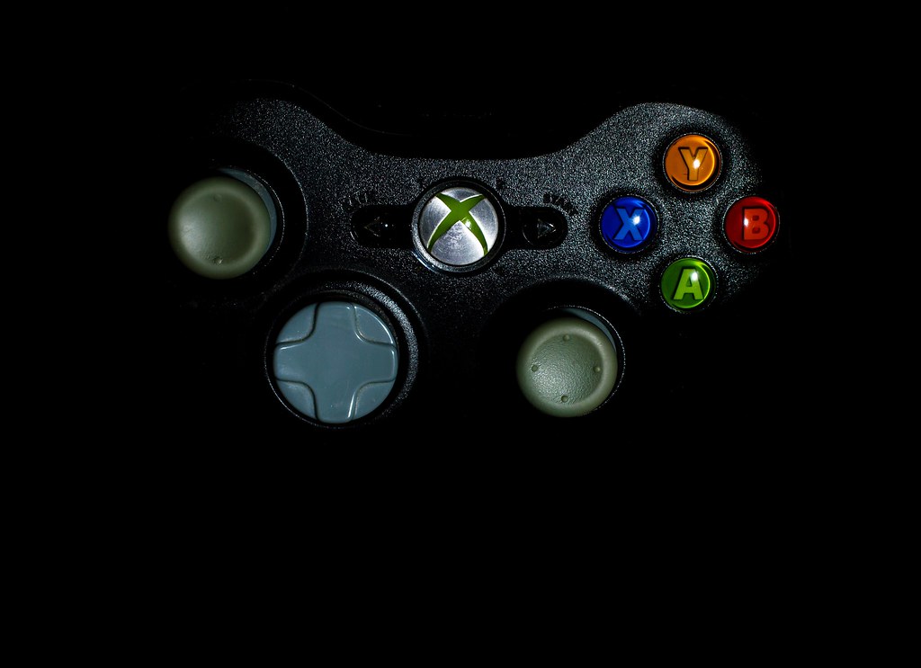 Une manette Xbox posée sur une surface sombre